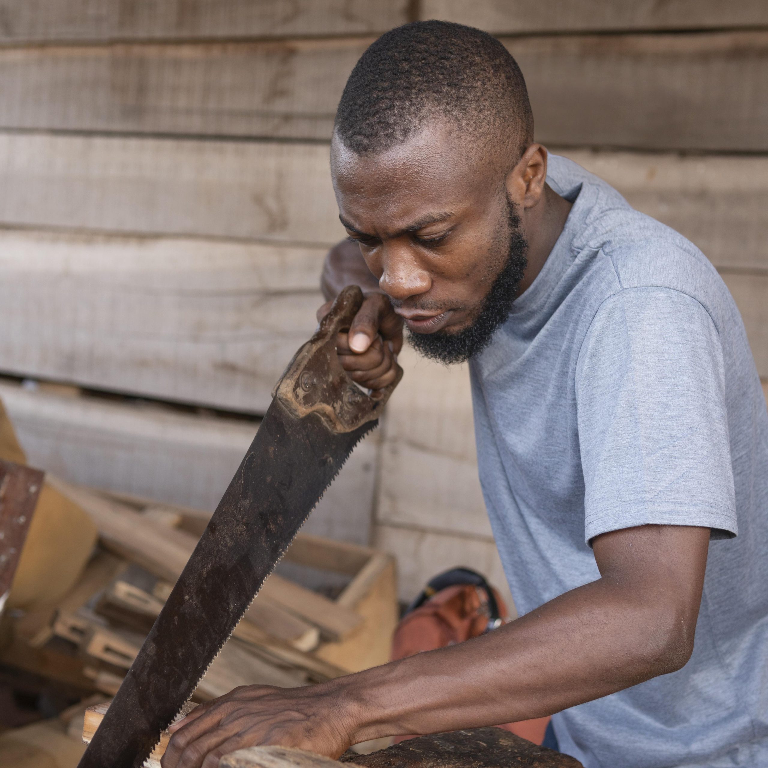 medium-shot-man-working-with-hand-saw